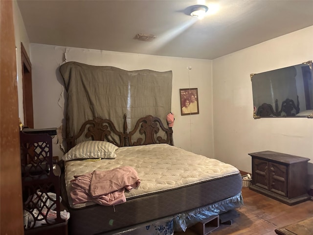 bedroom with hardwood / wood-style floors