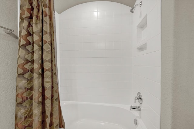 bathroom featuring shower / bathtub combination with curtain