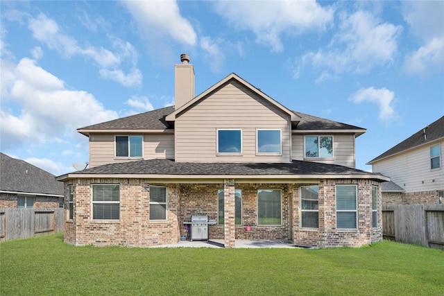 back of house featuring a patio and a lawn