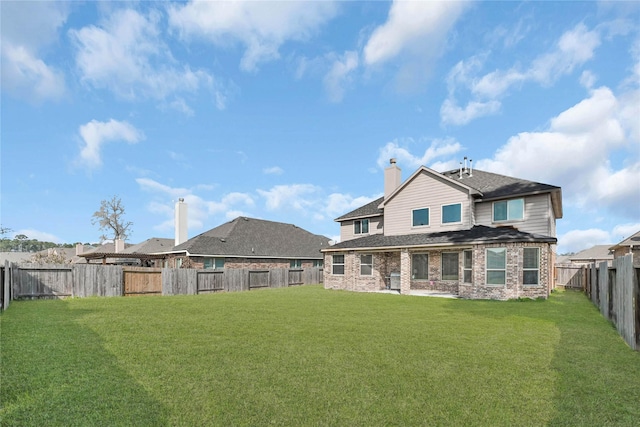 rear view of property with a lawn