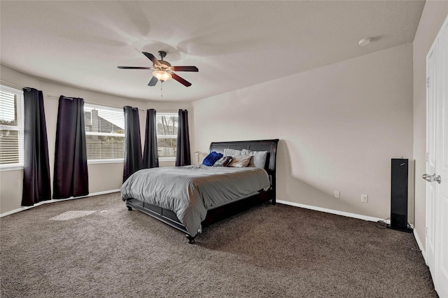 carpeted bedroom with multiple windows and ceiling fan