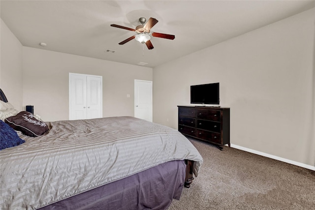 bedroom with ceiling fan, carpet, and a closet