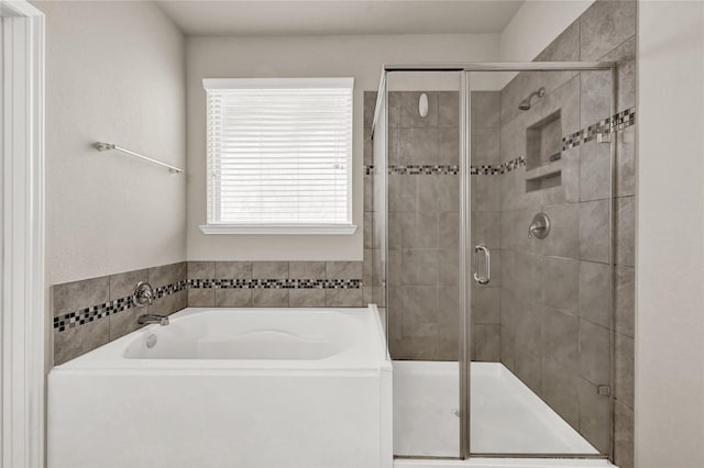 bathroom with separate shower and tub