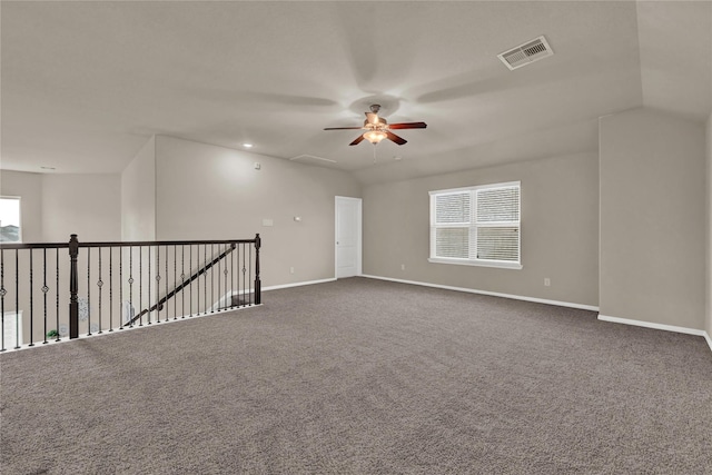 empty room with carpet, vaulted ceiling, and ceiling fan