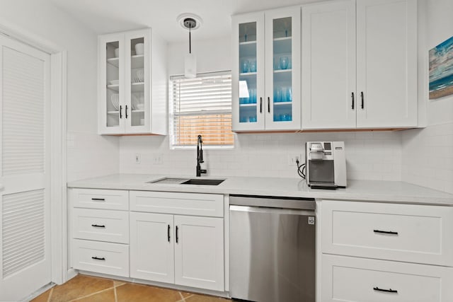 kitchen featuring dishwasher, decorative backsplash, pendant lighting, sink, and white cabinetry