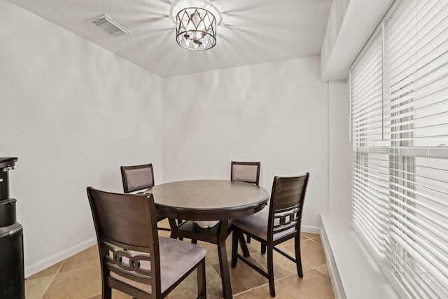 dining space with an inviting chandelier and light tile patterned floors