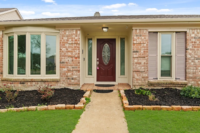 doorway to property featuring a lawn