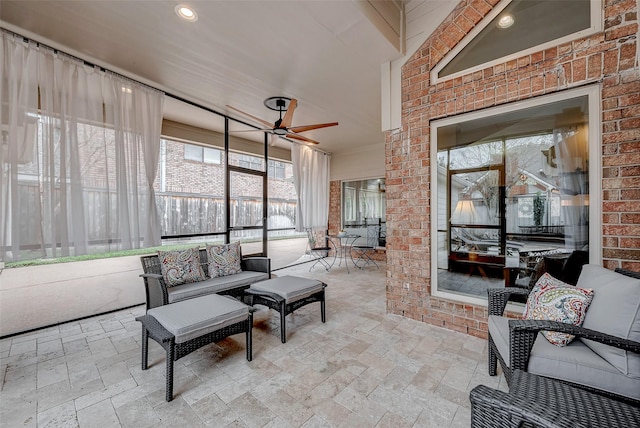 sunroom / solarium with a ceiling fan