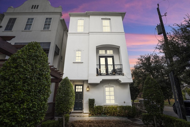 view of front facade featuring french doors and a balcony