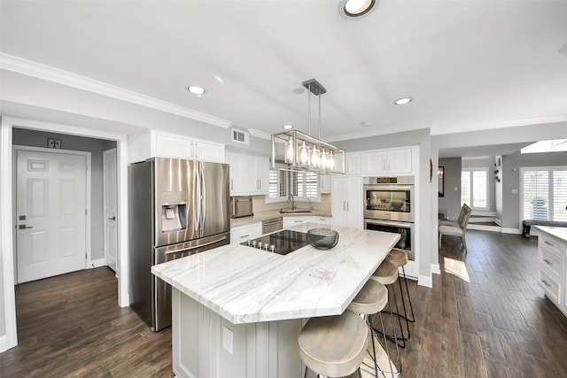 kitchen featuring appliances with stainless steel finishes, dark wood-style flooring, a sink, and white cabinetry