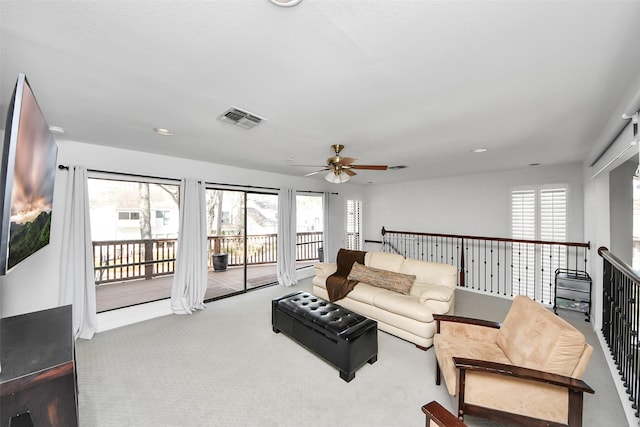 carpeted living area with recessed lighting, a healthy amount of sunlight, and visible vents