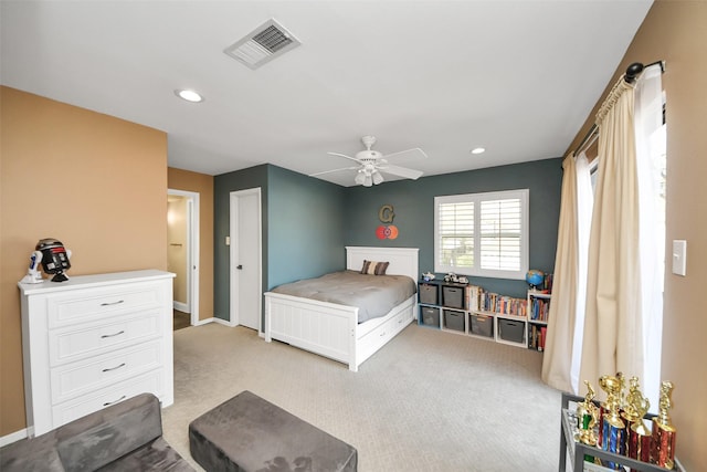 bedroom with light colored carpet, visible vents, and recessed lighting