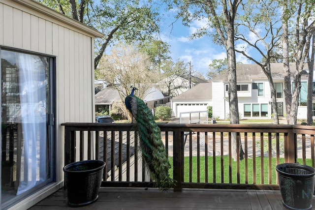 deck with a residential view and a lawn