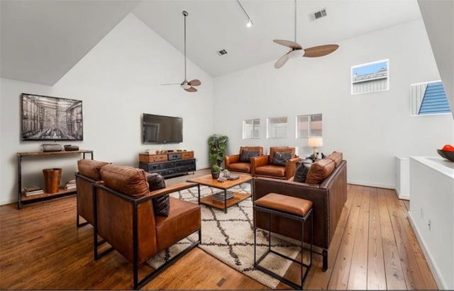 living room featuring high vaulted ceiling, hardwood / wood-style floors, ceiling fan, and track lighting