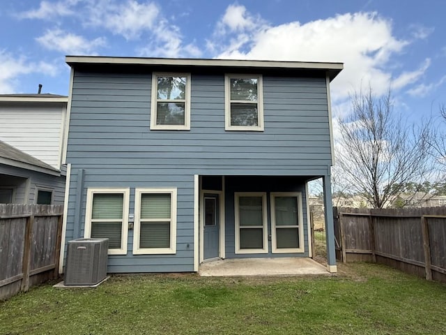 back of property featuring a patio, central air condition unit, and a yard