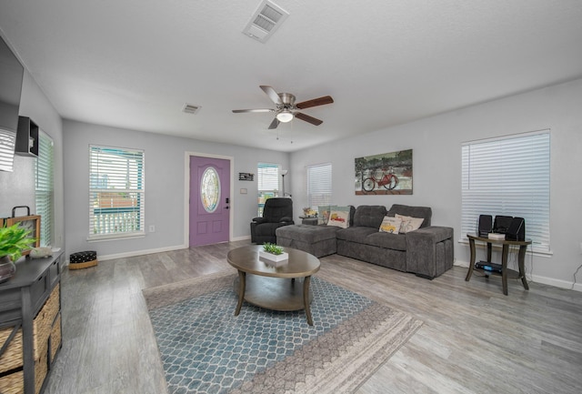 living room with light wood-type flooring and ceiling fan