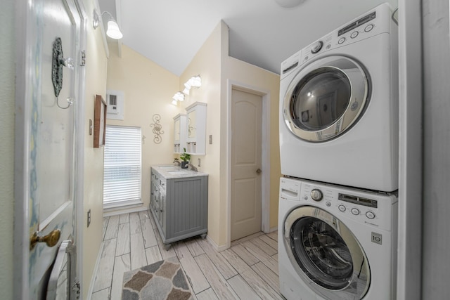 laundry area featuring sink and stacked washing maching and dryer