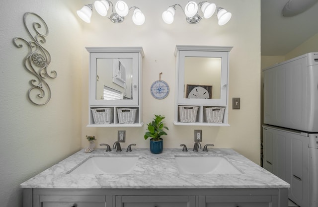 bathroom with vanity and stacked washer and clothes dryer