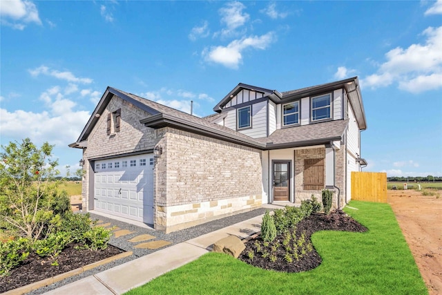 view of front of house with a front yard and a garage