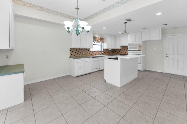 kitchen featuring white appliances, backsplash, white cabinetry, a kitchen island, and decorative light fixtures