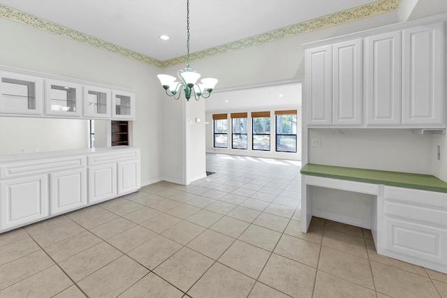 unfurnished dining area with light tile patterned floors and a chandelier