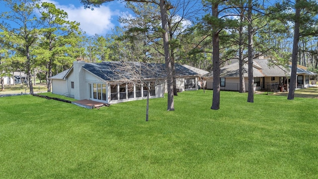 view of yard featuring a sunroom