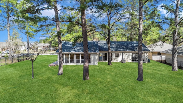 exterior space with a sunroom and a front lawn