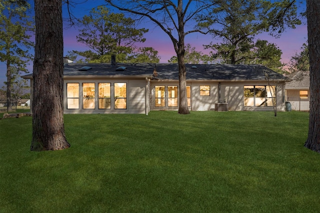 back of property with a lawn