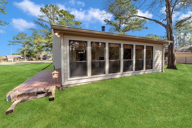 rear view of property with a yard