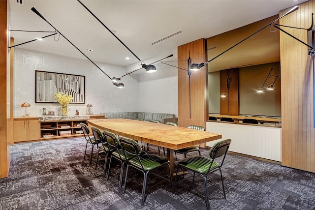 dining room featuring dark colored carpet