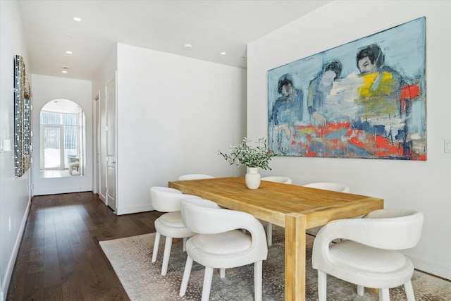 dining area featuring dark wood-type flooring