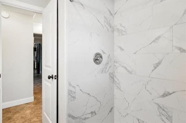 bathroom with a tile shower