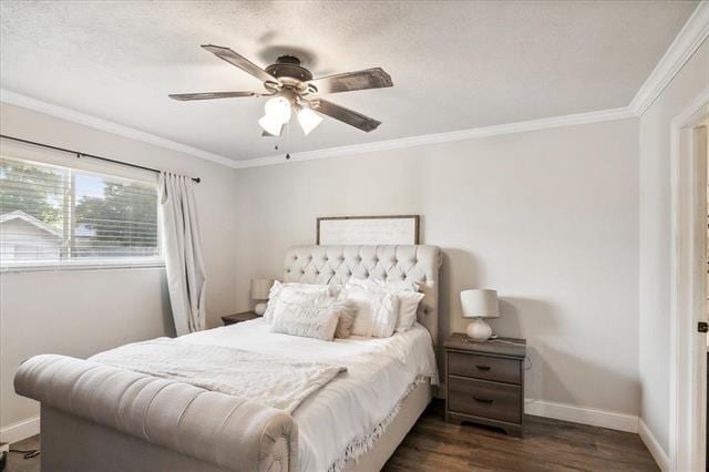 bedroom featuring ceiling fan, dark hardwood / wood-style flooring, and ornamental molding