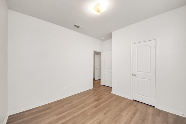 unfurnished bedroom featuring light wood-style floors, visible vents, and baseboards