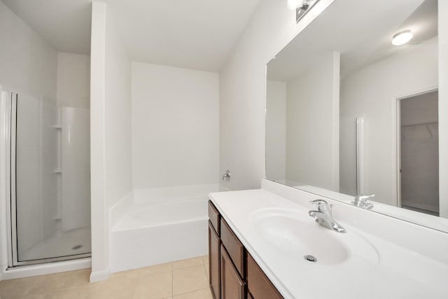 bathroom featuring a shower stall, vanity, a bath, and tile patterned floors