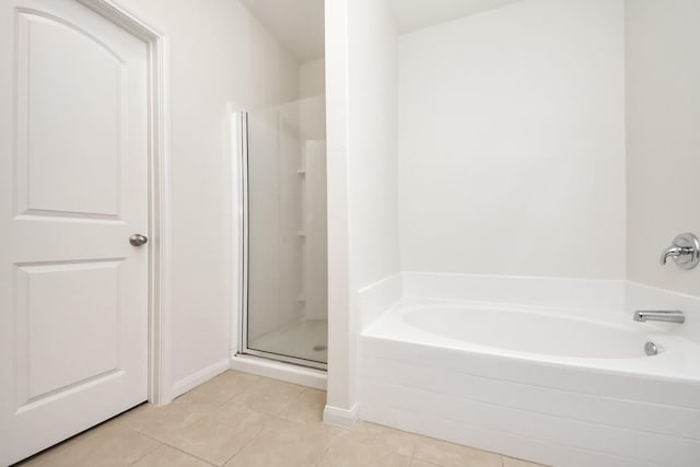 full bath with a stall shower, a bath, and tile patterned floors