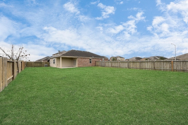 view of yard with a fenced backyard