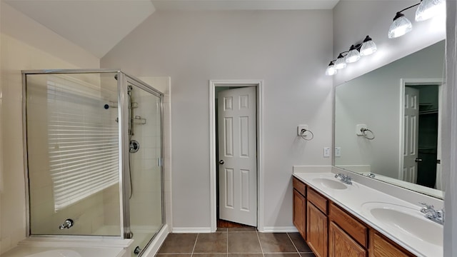 bathroom with lofted ceiling, tile patterned flooring, vanity, and a shower with door