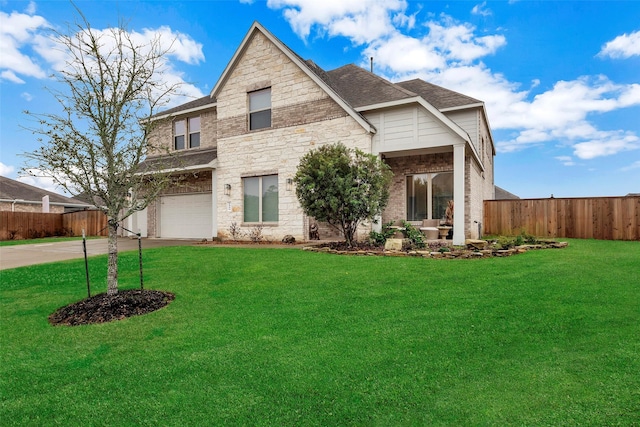 view of front of property with a front yard and a garage