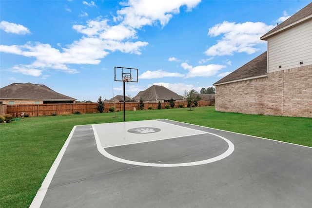 view of sport court featuring a lawn