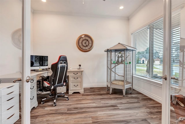 office space with light hardwood / wood-style floors and ornamental molding