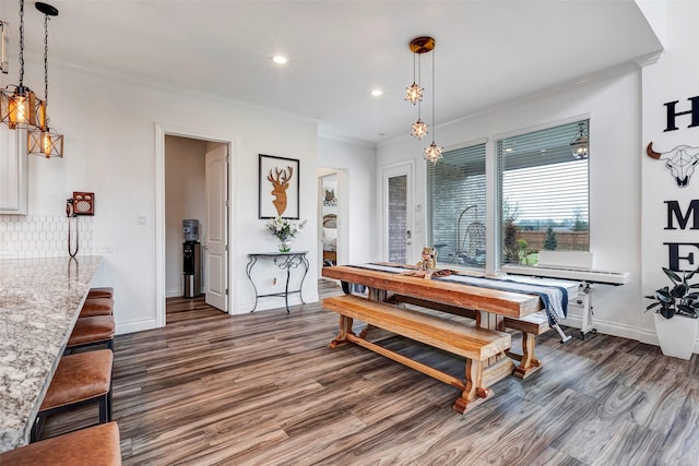 dining area with dark hardwood / wood-style flooring and ornamental molding