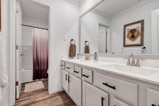 bathroom featuring hardwood / wood-style flooring, shower / bath combo with shower curtain, vanity, and ornamental molding