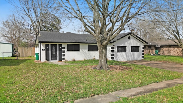 view of front of house with a garage and a front lawn