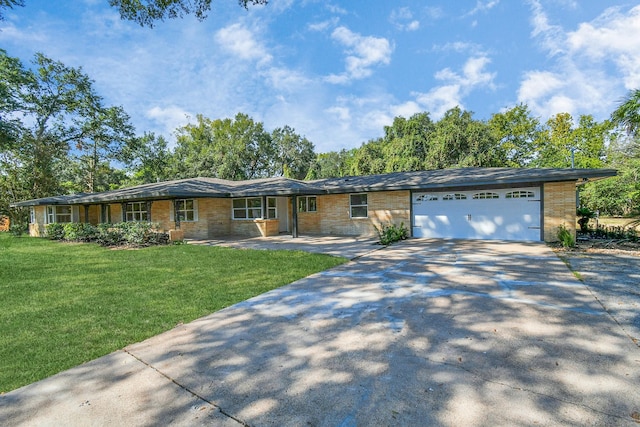 ranch-style home with a front yard and a garage