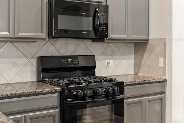 kitchen with backsplash, black appliances, gray cabinetry, and light stone counters