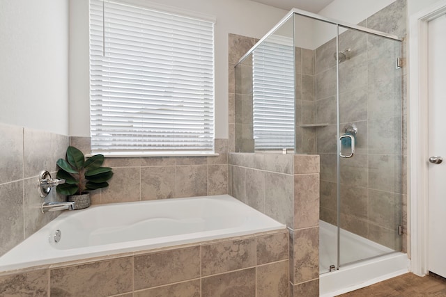 bathroom featuring separate shower and tub