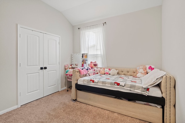 bedroom featuring a closet, lofted ceiling, and carpet flooring