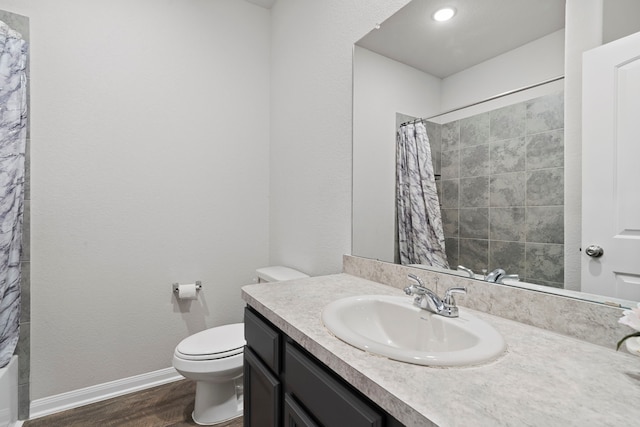 full bathroom with hardwood / wood-style flooring, vanity, toilet, and shower / tub combo