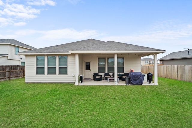 rear view of house with a patio area and a lawn